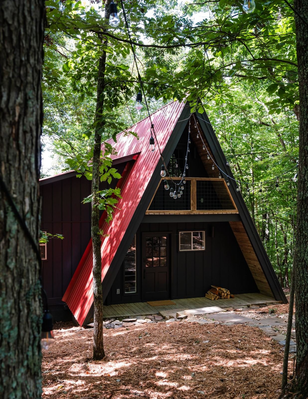 The Catherinne: black A-frame with a red roof among the trees near Blairsville, Georgia